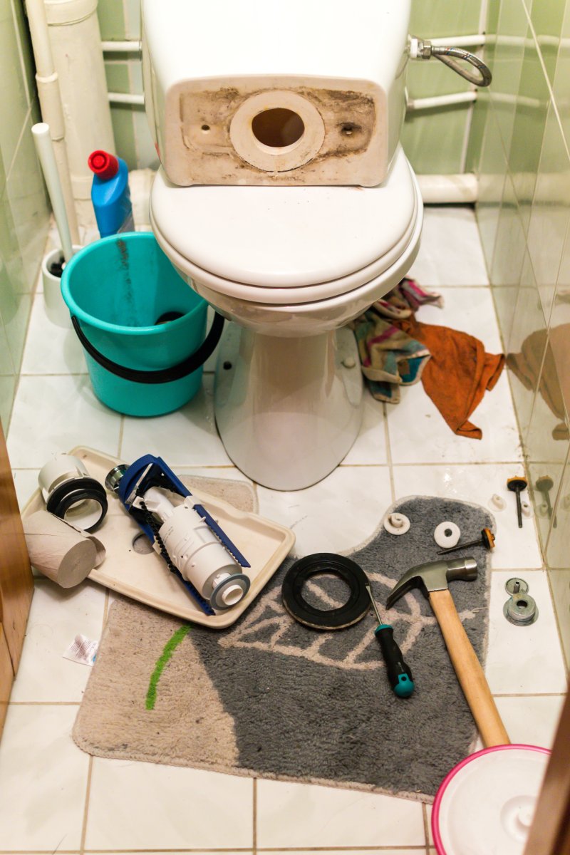 New toilet being installed in a Hackney bathroom